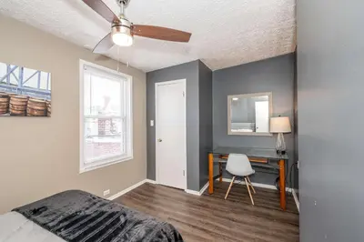 a bedroom with a bed and a desk with a chair at Monmouth Loft 4 - Walk to Shops in Newport