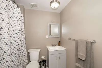 a bathroom with a toilet and a sink and a mirror at Monmouth Loft 4 - Walk to Shops in Newport
