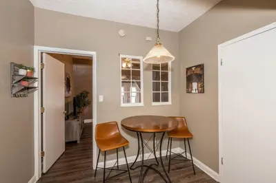 a dining room with a table and two stools at Monmouth Lofts - Newport Lofts Sleep 10 in Newport