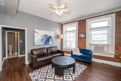 a living room with a leather couch and a table at Monmouth Lofts - Newport Lofts Sleep 10 in Newport