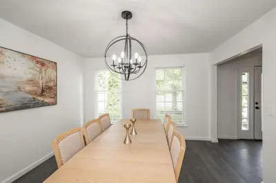 a dining room with a table with chairs and a chandelier at Lark Meadow Retreat Sleeps 10 in Mason