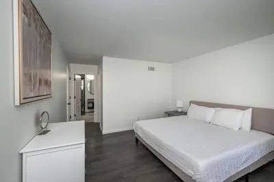 a bedroom with a white bed and a white dresser at Lark Meadow Retreat Sleeps 10 in Mason