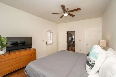 a bedroom with a bed and a flat screen tv at Cityscape Escape - Local Eateries in Cincinnati