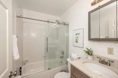 a bathroom with a shower and a sink and a toilet at Cityscape Escape - Local Eateries in Cincinnati