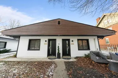 a small white house with a brown roof at Chic City Retreat 89 For 2 in Columbus