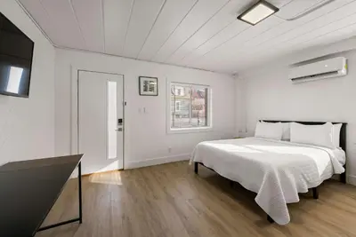 a white bedroom with a bed and a window at Chic City Retreat 89 For 2 in Columbus