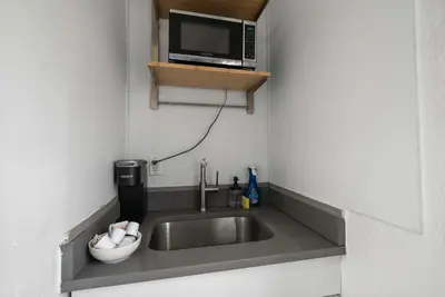 a kitchen with a sink and a microwave at Chic City Retreat 93I in Columbus