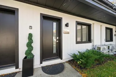a house with a plant on the side of it at Chic City Retreat 93I in Columbus