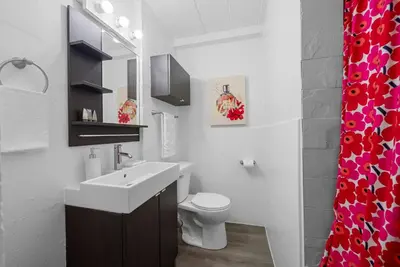 a white bathroom with a sink and a toilet at Chic City Retreat 87 in Columbus