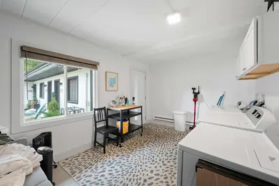 a kitchen with a sink and a table and a window at Chic City Retreat 93B in Columbus
