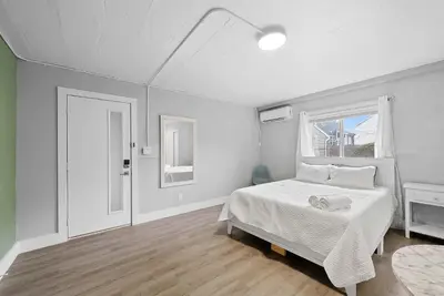 a white bedroom with a bed and a window at Chic City Retreat 93D in Columbus