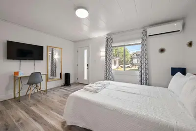 a white bedroom with a bed and a window at Chic City Retreat 93F in Columbus
