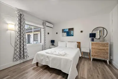 a white bedroom with a bed and a window at Chic City Retreat 93F in Columbus