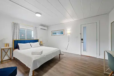 a white bedroom with a large bed and a window at Chic City Retreat 93G in Columbus