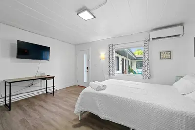 a white bedroom with a bed and a window at Chic City Retreat 93H in Columbus