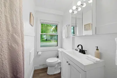 a white bathroom with a sink and a toilet at Chic City Retreat 93H in Columbus