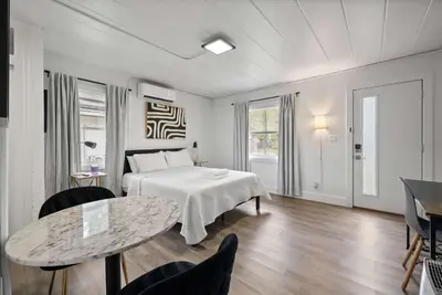 a bedroom with a bed and a table and chairs at Chic City Retreat 97 in Columbus