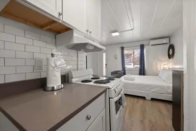 a kitchen with a stove and a bed in a room at Chic City Retreat 99 For 2 in Columbus