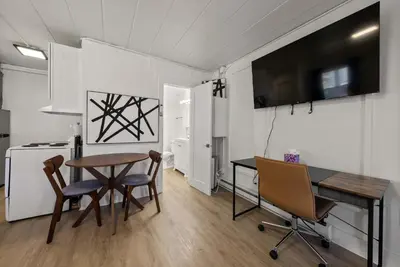 a kitchen and dining room with a table and chairs at Chic City Retreat 99 For 2 in Columbus