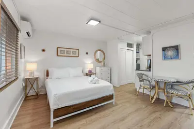a bedroom with a bed and a table and chairs at Chic City Retreat 93J For 2 in Columbus