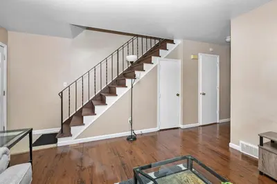 an empty living room with stairs in a house at Cozy 2 bedroom apartment in Dayton