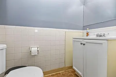 a bathroom with a white toilet and a sink at Cozy 2 bedroom apartment in Dayton