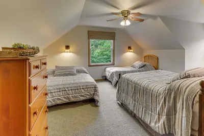 a bedroom with two beds and a ceiling fan at 2 Mi to Woodbury Wildlife Area Cozy Farmhouse! in Warsaw