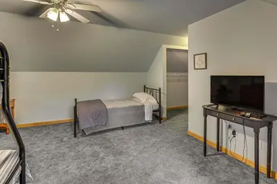 a bedroom with a bed and a flat screen tv at 2 Mi to Woodbury Wildlife Area Cozy Farmhouse! in Warsaw