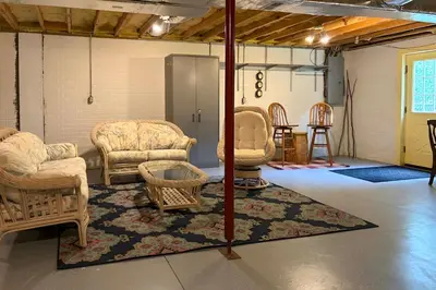 a living room with chairs and a rug at 2 Mi to Woodbury Wildlife Area Cozy Farmhouse! in Warsaw