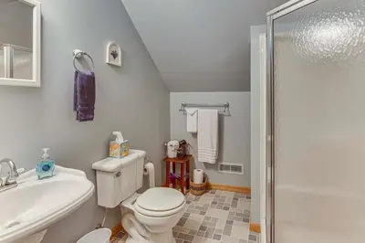 a bathroom with a toilet and a sink and a shower at 2 Mi to Woodbury Wildlife Area Cozy Farmhouse! in Warsaw