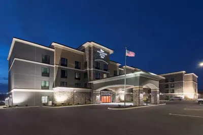 a hotel with an american flag in a parking lot at Homewood Suites by Hilton Cleveland/Sheffield in Avon