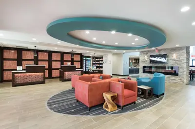 a lobby with couches and chairs and a fireplace at Homewood Suites by Hilton Cleveland/Sheffield in Avon