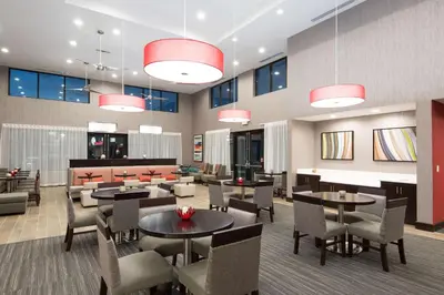 a restaurant with tables and chairs in a room at Homewood Suites by Hilton Cleveland/Sheffield in Avon