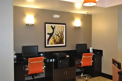 an office with two desks with two monitors and orange chairs at Holiday Inn Express Salem by IHG in Salem