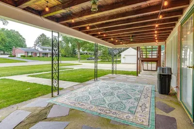 a patio with a mosaic rug on the ground at 3 Mi to Pro Football Hall of Fame Home with Yard! in Canton