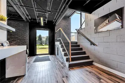 a room with a staircase and a brick wall at The Mulberry in Logan
