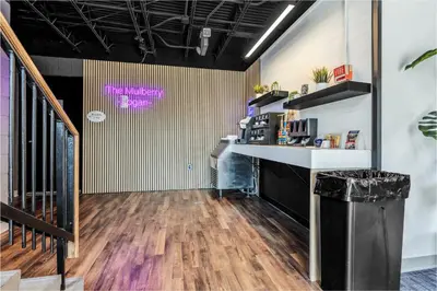 a lobby with a desk and a staircase in a room at The Mulberry in Logan