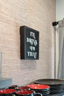 a sign that says ill drink to that on a wall at The Mulberry in Logan