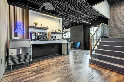 a lobby of a building with stairs and a counter at The Mulberry in Logan
