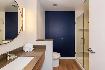 a bathroom with a toilet and a sink and a mirror at Fairfield Inn & Suites Dayton Beavercreek in Beavercreek