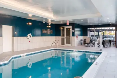 a swimming pool with blue water in a building at Fairfield Inn & Suites Dayton Beavercreek in Beavercreek
