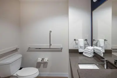 a bathroom with a toilet and a sink with towels at Fairfield Inn & Suites Dayton Beavercreek in Beavercreek