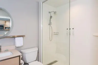 a bathroom with a shower with a toilet and a sink at TownePlace Suites Dayton Beavercreek in Beavercreek