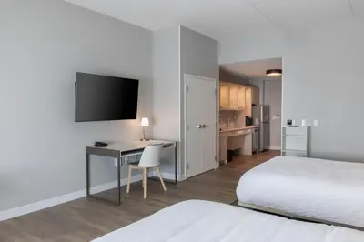 a hotel room with a desk and a bed and a tv at TownePlace Suites Dayton Beavercreek in Beavercreek