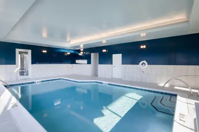 a large swimming pool in a bathroom with blue at TownePlace Suites Dayton Beavercreek in Beavercreek