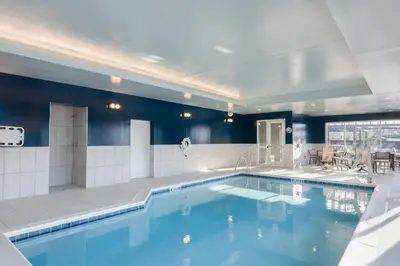a large swimming pool in a large room with blue walls at TownePlace Suites Dayton Beavercreek in Beavercreek