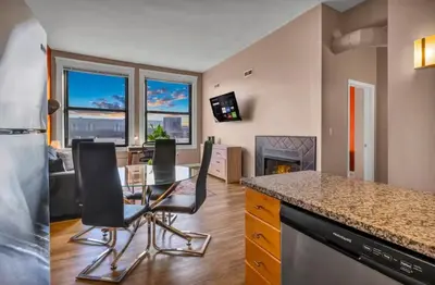 a kitchen with a table and chairs and a living room at 1Br in Heart of Downtown, Sauna, Prime Location in Cleveland
