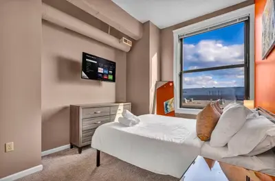 a bedroom with a bed and a large window at 1Br in Heart of Downtown, Sauna, Prime Location in Cleveland