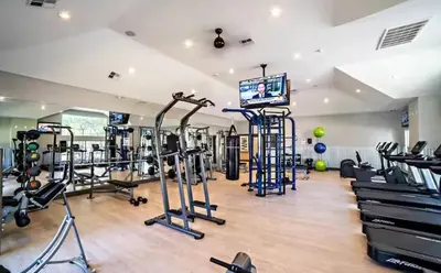 a gym with several tread machines and a flat screen tv at 1Br in Heart of Downtown, Sauna, Prime Location in Cleveland