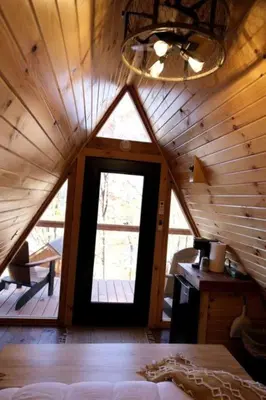a room with a large window in a wooden cabin at Secluded A-Frame Incredible for Water Activities by Tappan Lake in Ohio in Deersville